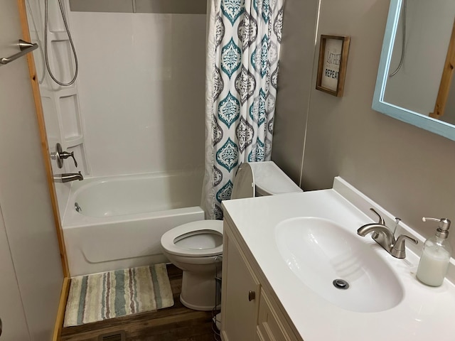bathroom with shower / bath combo, wood finished floors, vanity, and toilet