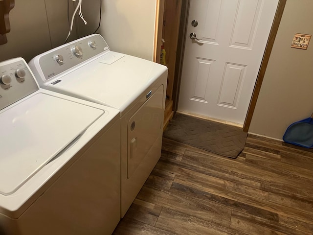 laundry room featuring separate washer and dryer, laundry area, and dark wood-type flooring