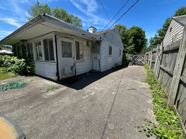 1054 S Hampton Rd, Columbus, OH 43227 - view of front of house featuring fence, a patio, and a chimney