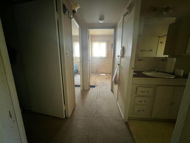 1054 S Hampton Rd, Columbus, OH 43227 - hallway featuring light carpet, a sink, and visible vents