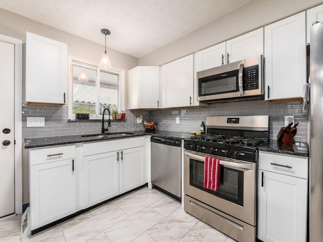 kitchen featuring a sink, white cabinetry, marble finish floor, and stainless steel appliances