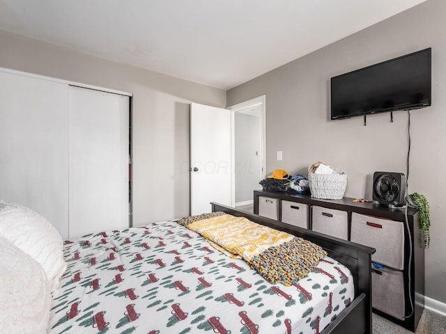bedroom featuring a closet, baseboards, and carpet floors