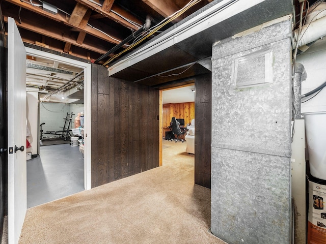 unfinished below grade area with wooden walls and heating unit