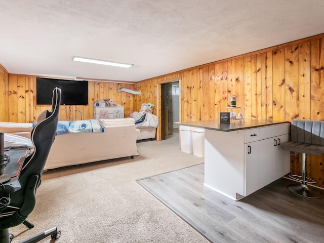 home office with wood walls and wood finished floors