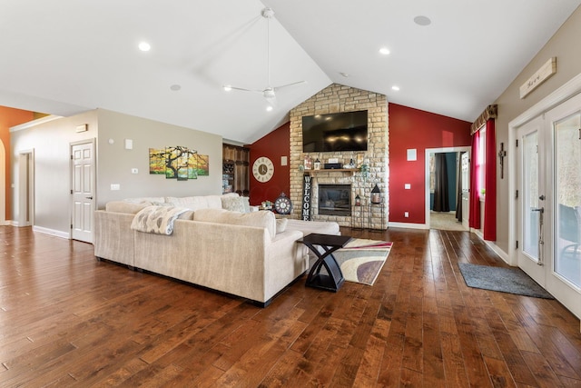 living area featuring dark wood-type flooring, ceiling fan, lofted ceiling, and a brick fireplace