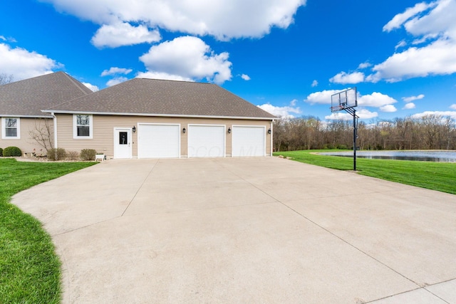 view of property exterior featuring concrete driveway, an attached garage, a water view, a shingled roof, and a lawn