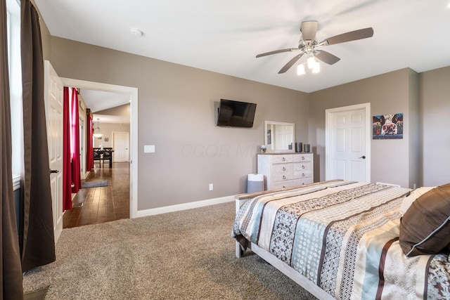 carpeted bedroom with baseboards and a ceiling fan