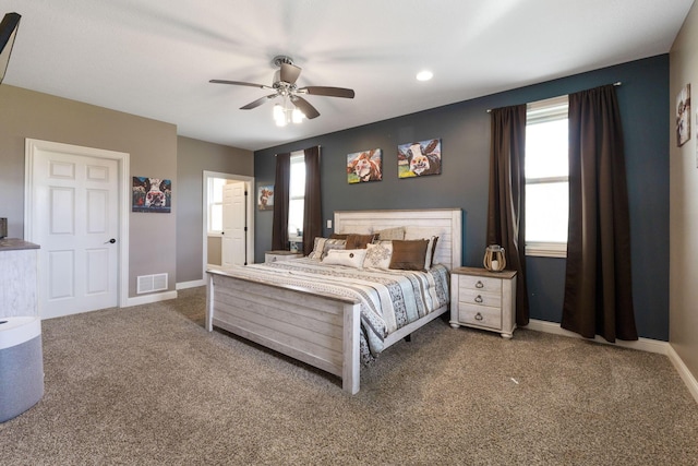 carpeted bedroom featuring visible vents, baseboards, and a ceiling fan