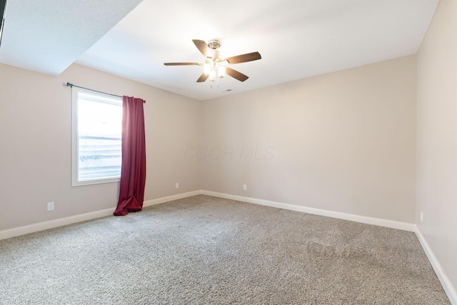 empty room featuring baseboards, a ceiling fan, and carpet floors