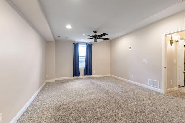 spare room featuring visible vents, ceiling fan, carpet flooring, and baseboards