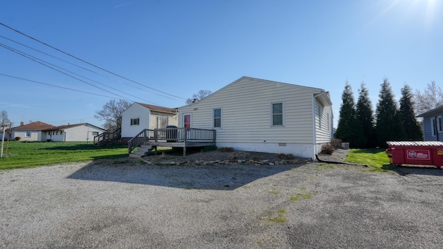view of front of house featuring a front yard, a deck, and crawl space