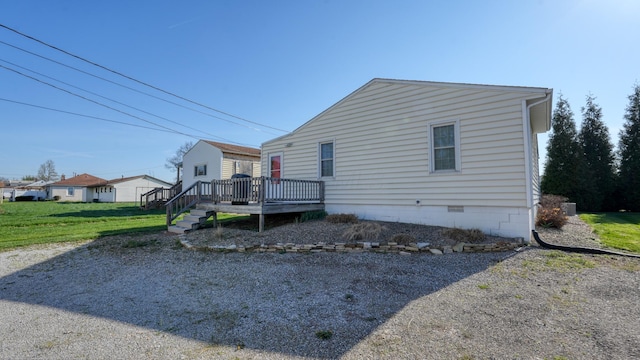 view of home's exterior with crawl space and a wooden deck