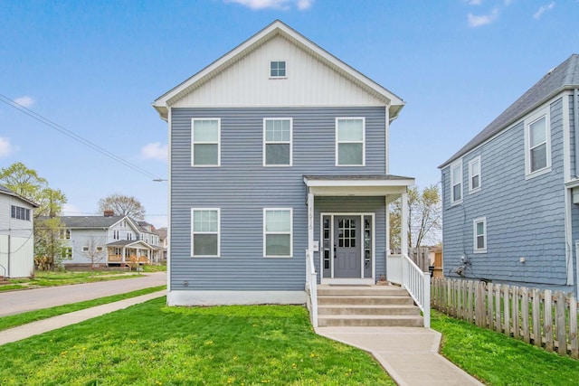 view of front of property featuring a front lawn and fence