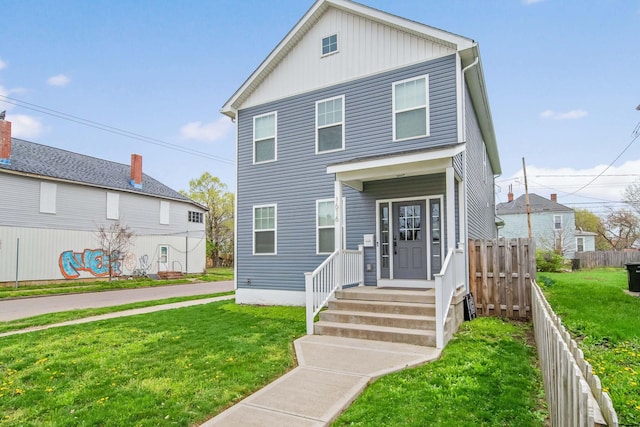 view of front of house with fence and a front yard