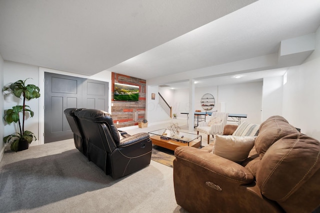 carpeted living area featuring baseboards and stairs