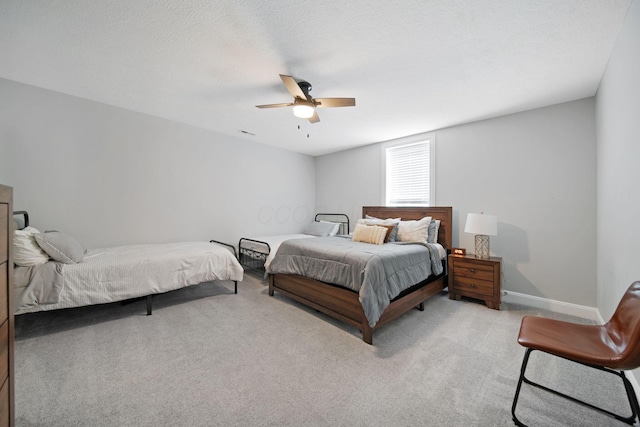 bedroom with visible vents, a ceiling fan, baseboards, and light carpet