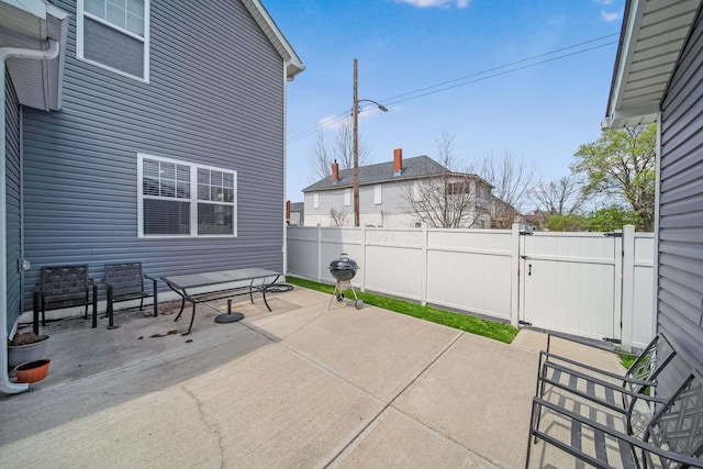 view of patio with fence and a gate