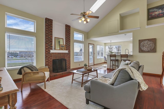 living room featuring baseboards, a fireplace, a ceiling fan, high vaulted ceiling, and wood finished floors