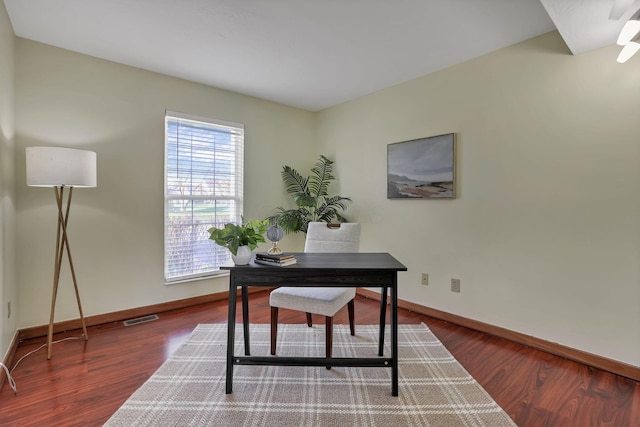 office area with visible vents, baseboards, and wood finished floors