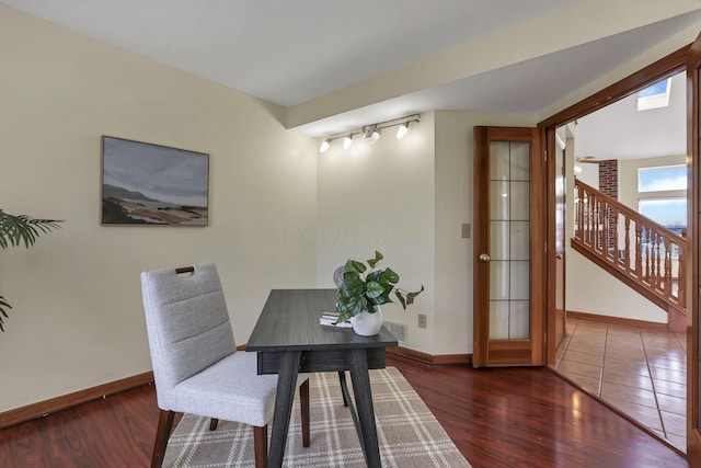 office area with baseboards and wood finished floors