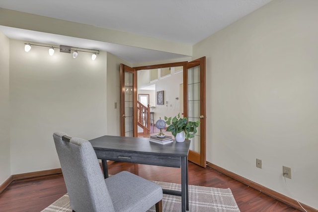 office area featuring track lighting, baseboards, and wood finished floors