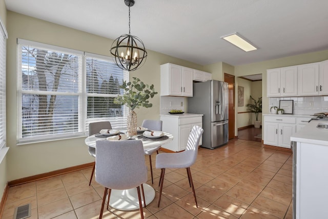 dining space featuring visible vents, a chandelier, light tile patterned floors, and a healthy amount of sunlight