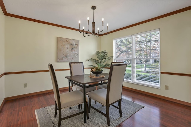 dining area with crown molding, wood finished floors, an inviting chandelier, and baseboards