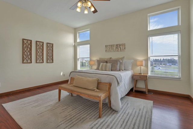 bedroom with wood finished floors, baseboards, and a ceiling fan