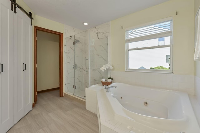 full bathroom with a marble finish shower and a whirlpool tub