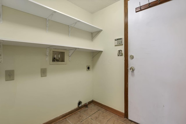 washroom featuring hookup for an electric dryer, baseboards, light tile patterned floors, washer hookup, and laundry area