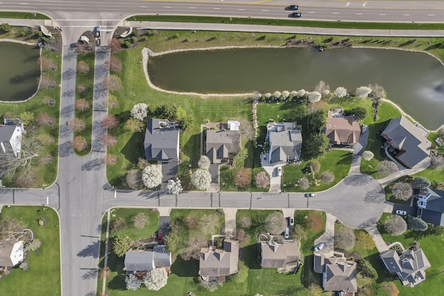 bird's eye view featuring a water view and a residential view