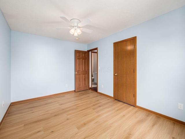 unfurnished bedroom with light wood-style flooring, a closet, baseboards, and a ceiling fan