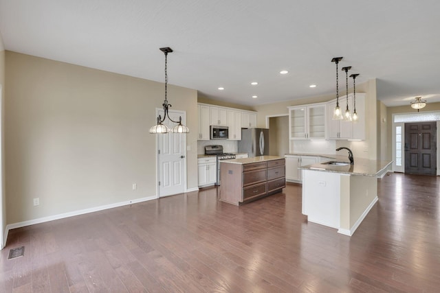 5351 Lilac Ave, Grove City, OH 43123 - kitchen featuring stainless steel appliances, dark wood-style floors, a kitchen island, recessed lighting, and white cabinetry