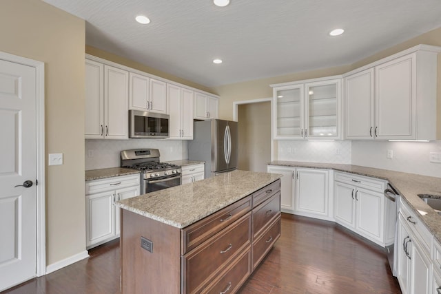 5351 Lilac Ave, Grove City, OH 43123 - kitchen featuring appliances with stainless steel finishes, glass insert cabinets, dark wood-type flooring, white cabinetry, and recessed lighting