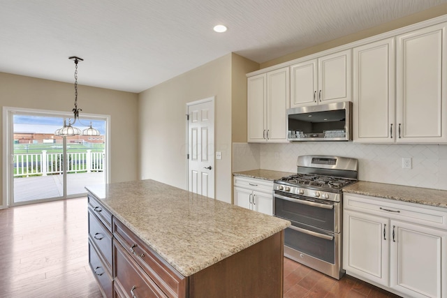 5351 Lilac Ave, Grove City, OH 43123 - kitchen with appliances with stainless steel finishes, dark wood-type flooring, tasteful backsplash, decorative light fixtures, and light stone countertops