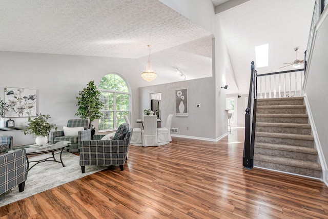 1148 Challis Springs Dr, New Albany, OH 43054 - living room featuring vaulted ceiling, stairs, wood finished floors, ceiling fan, and baseboards
