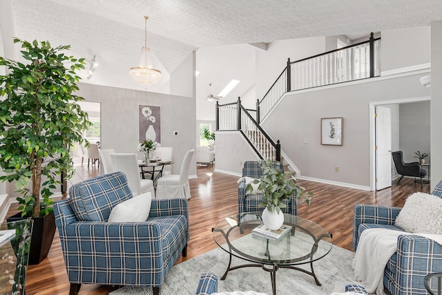 1148 Challis Springs Dr, New Albany, OH 43054 - living area featuring a textured ceiling, high vaulted ceiling, plenty of natural light, wood finished floors, and stairway