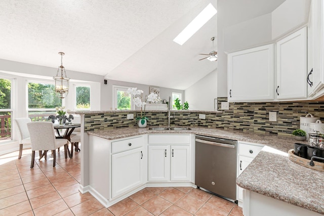 1148 Challis Springs Dr, New Albany, OH 43054 - kitchen with stainless steel dishwasher, light tile patterned flooring, a sink, a peninsula, and white cabinetry
