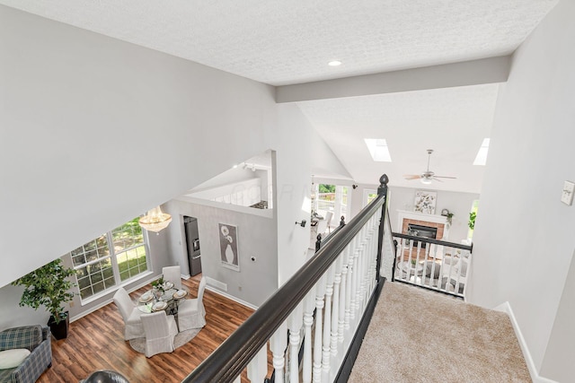 1148 Challis Springs Dr, New Albany, OH 43054 - corridor featuring a skylight, baseboards, a textured ceiling, and wood finished floors