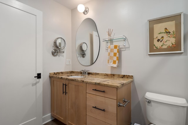 bathroom featuring toilet and vanity