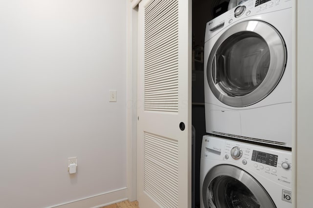 clothes washing area with laundry area and stacked washer and clothes dryer