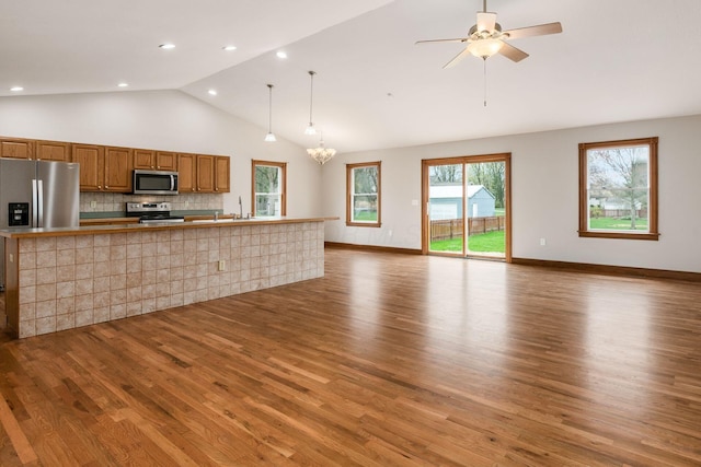 277 Cherrington Rd, Westerville, OH 43081 - unfurnished living room featuring recessed lighting, high vaulted ceiling, ceiling fan with notable chandelier, a sink, and wood finished floors