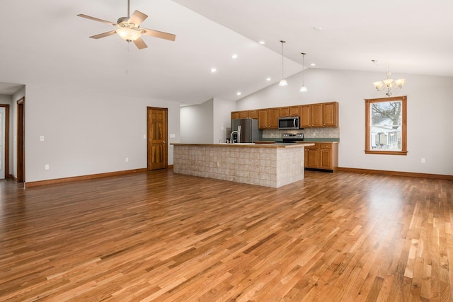 277 Cherrington Rd, Westerville, OH 43081 - kitchen with open floor plan, decorative light fixtures, light wood-style floors, stainless steel appliances, and ceiling fan with notable chandelier