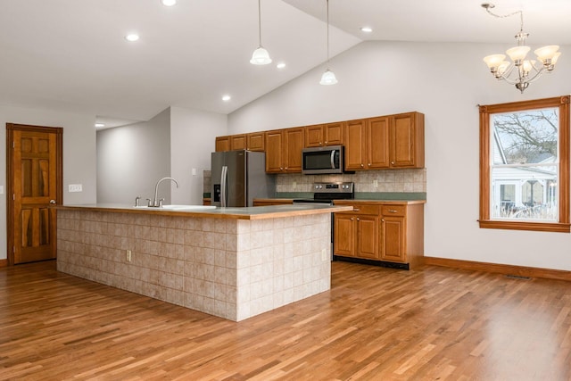 277 Cherrington Rd, Westerville, OH 43081 - kitchen with light wood-type flooring, brown cabinets, decorative backsplash, stainless steel appliances, and a sink