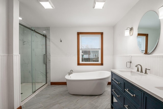 277 Cherrington Rd, Westerville, OH 43081 - full bathroom with a sink, a soaking tub, double vanity, a marble finish shower, and a wainscoted wall