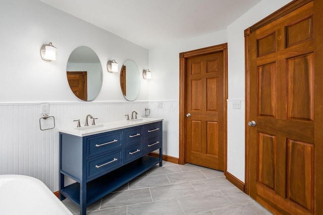 277 Cherrington Rd, Westerville, OH 43081 - full bathroom with a soaking tub, double vanity, a sink, and a wainscoted wall