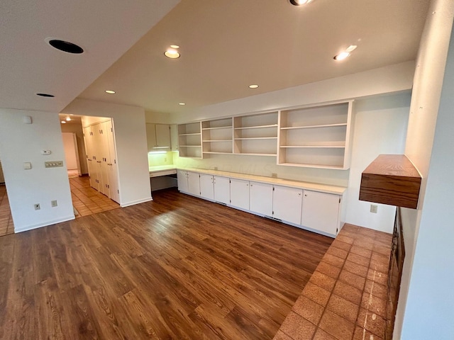 interior space with open shelves, white cabinets, light countertops, dark wood finished floors, and recessed lighting