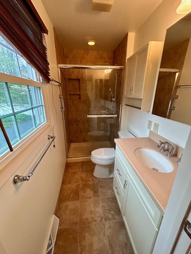 full bath featuring toilet, vanity, visible vents, and a stall shower