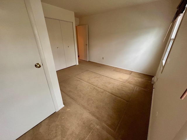 unfurnished bedroom featuring a closet and carpet