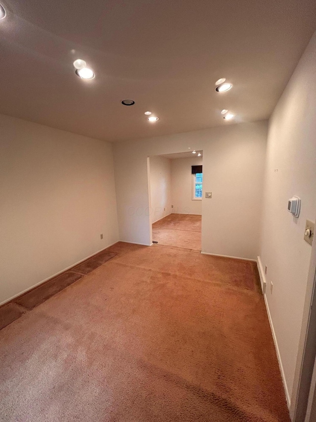 spare room featuring light colored carpet and recessed lighting